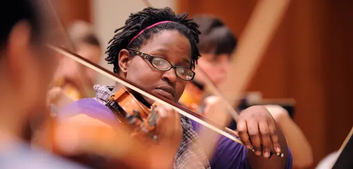 Orchestra student playing a violin